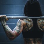 woman carrying barbell