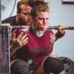woman carrying barbells